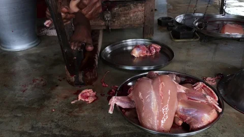 A butcher cutting chicken Stock Footage 102026372