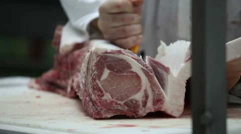 Butcher cutting meat Stockbeeldmateriaal 33746436