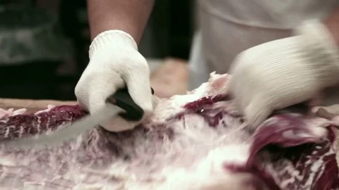 Butcher cutting meat  Video stock 83799724