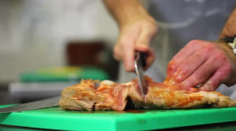 Butcher cutting meat into pieces Stock Footage 38629643