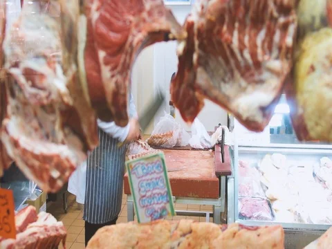 Butcher cutting meat with sharp knife Stock Footage 76972261
