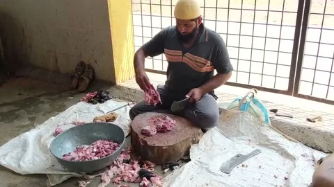 Butcher cutting piece of mutton or lamb meat for waiting customers. Stock Footage 172191902