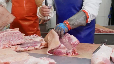 Butcher cutting pork meat from bones for preparing delicacies in meat shop. Stock Footage 246328801