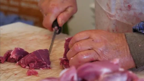 Butcher cutting pork meat on the table. Slow moton, pan shot. Stock-Footage 83882182