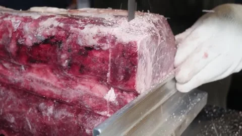 Butcher Cutting Raw Beef Ribs with a Bandsaw Video stock 332814301