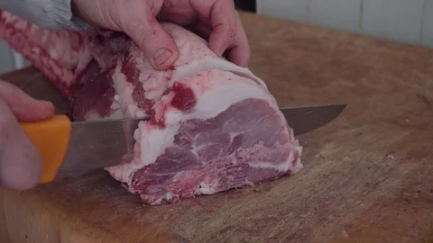 Butcher cutting a slice of meat Stock Footage 90623730