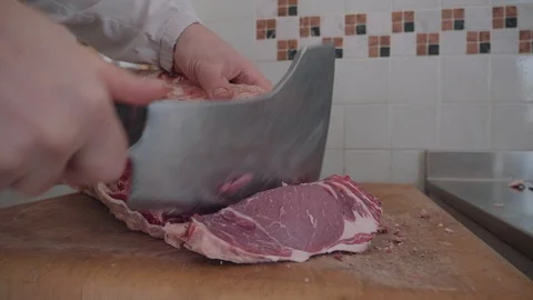 Butcher cutting a slice of meat Stock Footage 90625624