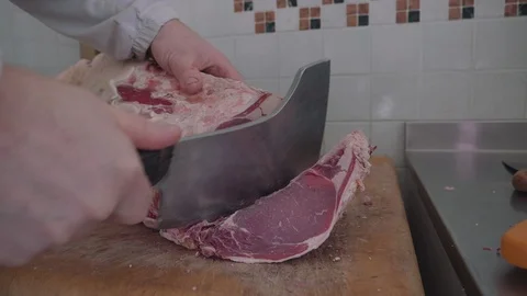 Butcher cutting a slice of meat Stock Footage 90697202