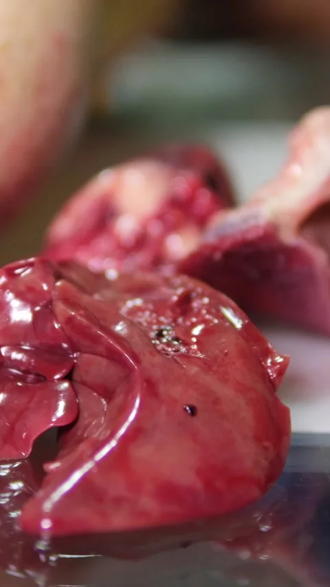 Butcher a goose process of cutting up a goose Step by step getting the liver and Stock Footage 303486931