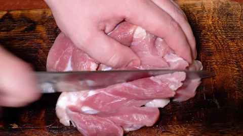 Butcher prepares cuts of pork Stock Footage 252123306