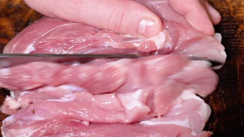 Butcher prepares cuts of pork Stock Footage 252123333