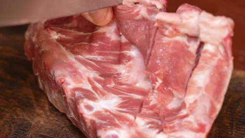 Butcher prepares cuts of pork Stock Footage 255126441