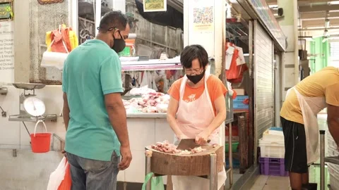Butcher preparing chicken for customer Stock Footage 247637688
