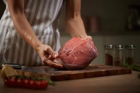 Butcher preparing fresh raw beef for cooking Stock Photos