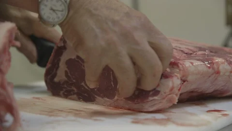 Butcher preparing raw beef Stock Footage 104872901