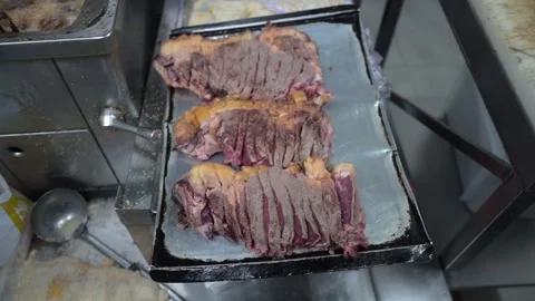 Butcher preparing sliced t bone steaks in a commercial kitchen Video stock 323792380