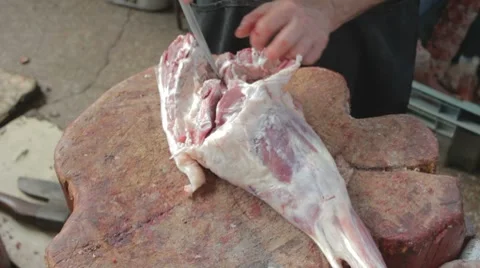 Butcher separating bone from pulp on mutton's leg Stock Footage 8367857