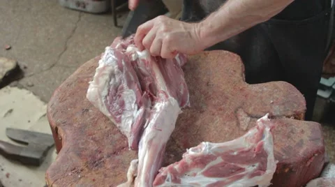 Butcher separating large bone of mutton's leg from meat Stock Footage 8367922