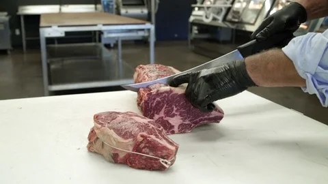 Butcher showing a chunk of meat to camera Stock Footage 83457037