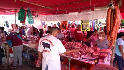 Butcher shows to a client some pieces of meat Stock Footage 137264198
