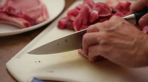 Butcher slicing beef steak onto small chunks - close up Stock Footage 45170981