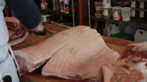Butcher uses hack saw on pork 3 Stock Footage 42231516
