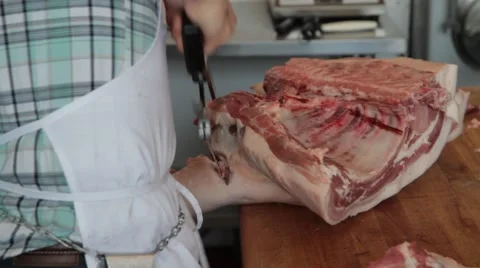 Butcher uses hack saw on pork 1 Stock Footage 42231681