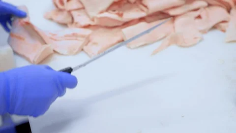 Butchers cut pork at the meat processing plant in the cutting shop. Stock-Footage 129579769