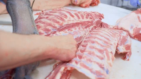 Butchers cut pork at the meat processing plant in the cutting shop. Stock-Footage 129579890