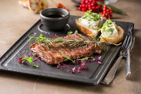 Butcher's steak, on a stone plate Stock Photos