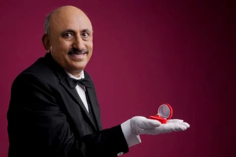 Butler displaying a ring Stock Photos