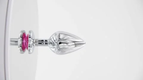 Butt plug spinning on mirror surface Stock Footage 277357108