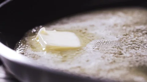 Butter being heated in a pan Stock Footage 72415210