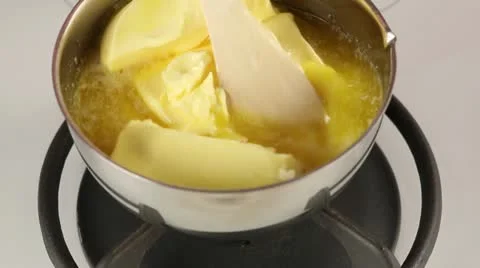 Butter being melted in a pot Stock Footage 24671450