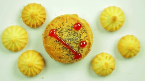 Butter biscuits with culinary paint painted with a funny emoticon and surrounded Stock Footage 98257642