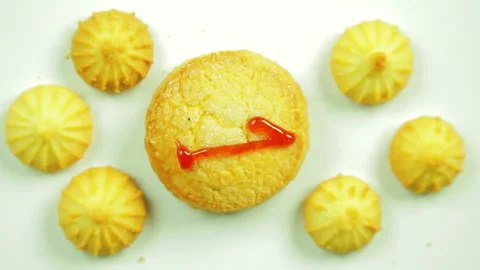 Butter biscuits with painted figure one culinary paint surrounded by small Stock Footage 98310013