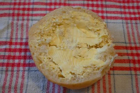 Butter on a bread roll Stock Photos