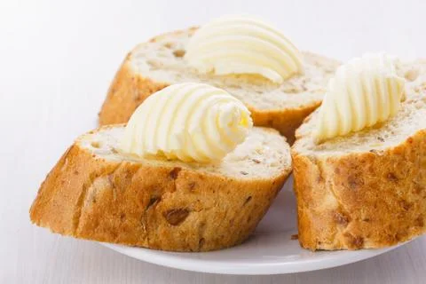 Butter on bread slices Stock Photos