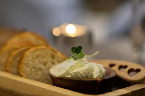 Butter with bread on a wooden board in the restaurant Stock Photos