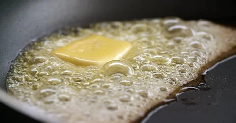 Butter bubbling in frying pan Stock Footage 61076323