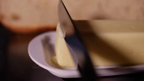 Butter close up with knife being cut in soft butter slow motion Stock Footage 150607216