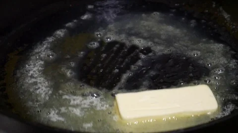 Butter on a frying pan. Stock Footage 88995500