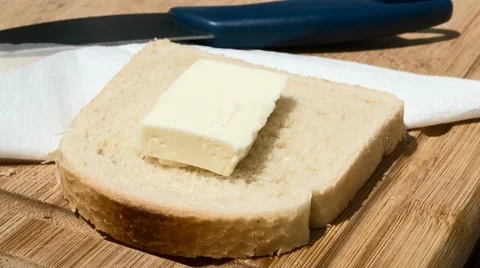 Butter melting on a slice of bread Stock Footage 52052495
