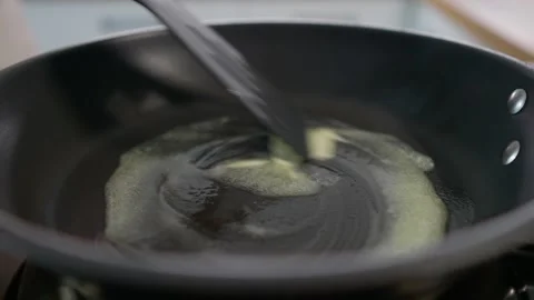 The butter melts in the pan. Stock Footage 276294158