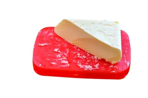Butter on a red stand, a triangular piece of butter, a large piece of butter Stock Photos