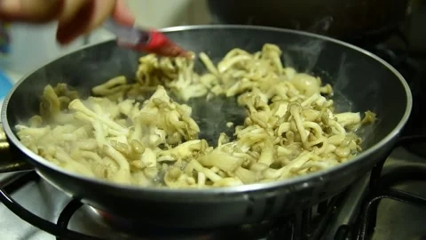 Butter shimeji being prepared in skillet Stock Footage