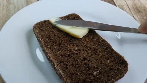 Butter is spread on black bread Stock Footage 199019458