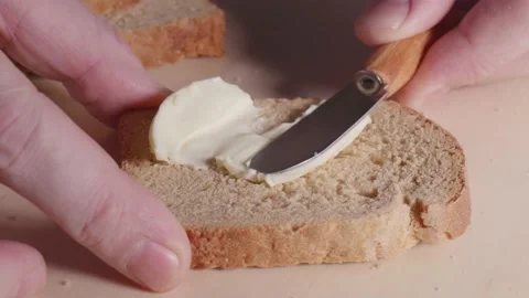 Butter spreading on bread slow mo close-up Stock Footage 146698402