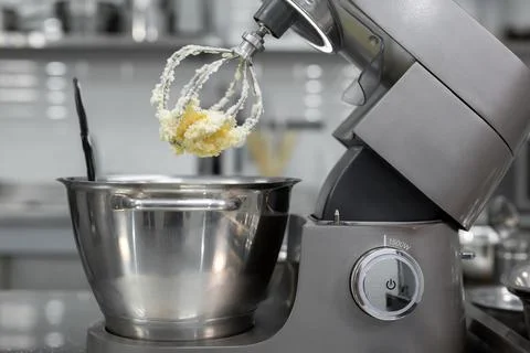 Butter with sugar on the Corolla of the kitchen machine, mixer Stock Photos