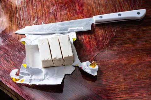 Butter on the table with a knife Stock Photos